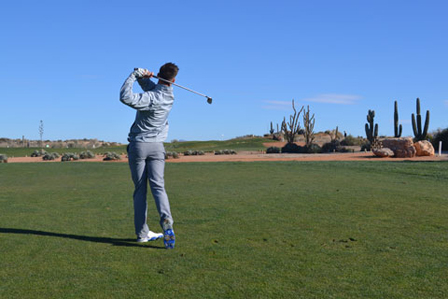 A Hartpury Golf Academy student plays their approach shot into Hole 1 'Cactus Point' on the Indiana course at Desert Springs